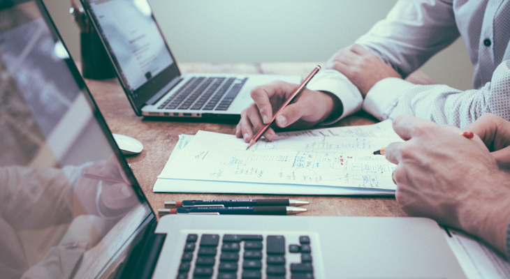 Photo of two people planning a website on paper